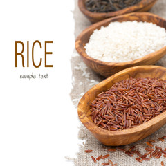 three varieties of uncooked rice in wooden bowl, selective focus