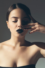Fashionable attractive woman with black lipstick