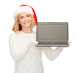 woman in santa helper hat with laptop computer