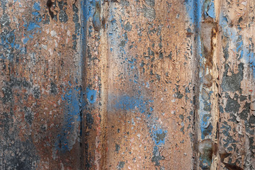 Weathered tin surface with peeling paint as background