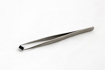 Microchip on Tweezers isolated on white