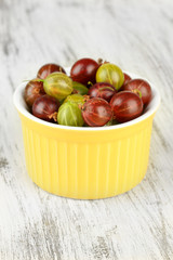 Fresh gooseberries in bowl on table close-up