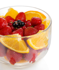 Useful fruit salad in glass cup isolated on white
