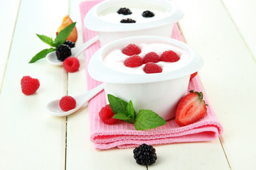 Delicious yogurt with fruit and berries on table close-up
