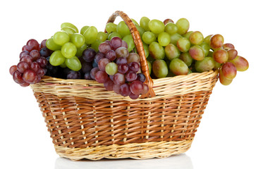 Fresh grape in wicker basket, isolated on white