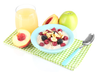 Oatmeal in bowl with berries isolated on white