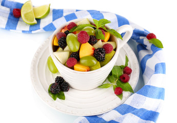 Fruit salad in cup near napkin isolated on white