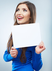 Fototapeta premium Teenager girl hold white blank paper. Young smiling woman show