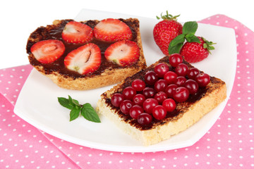 Delicious toast with berries on plate close-up