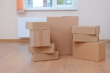 Empty room with stack of cartons: moving house concept