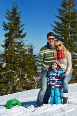 Fototapeta na wymiar family having fun on fresh snow at winter