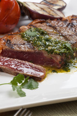 Piece of Medium Rare Steak with Spicy Herb Sauce