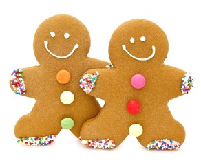 Two Christmas gingerbread men over a white background