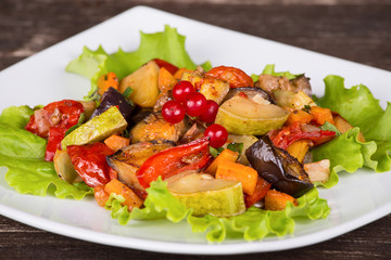 Roasted vegetables on a white plate, close up