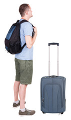 Back view of young man traveling with suitcas.