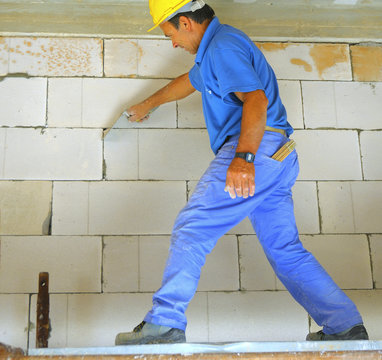 construction worker performs an internal bricklayer wall