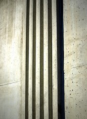 Background vertical texture from light rough concrete bands