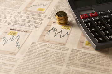 Newspaper stock market with calculator and money