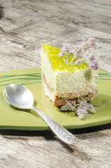 Slice of lime cheesecake with mint flowers