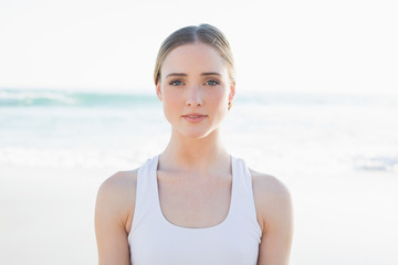 Beautiful young woman sitting on the beach