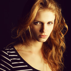 Naklejka premium Portrait of a fashionable red-haired (ginger) model in t-shirt