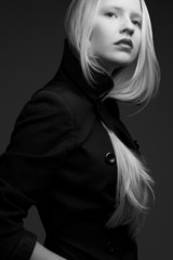 Portrait of a beautiful fashionable model in black coat