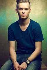Obraz premium Portrait of a young man with very handsome face in blue t-shirt