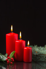 Christmas candles with evergreen decorations