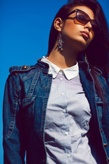 Stylish brunette in trendy sunglasses. Fashion portrait