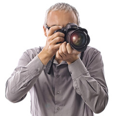 Professional photographer taking pictures with camera on white