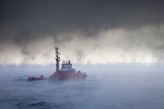 Dark image of ship on sea during a violent blizzard.
