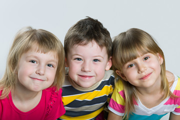 Closeup portrait of three cheerful children