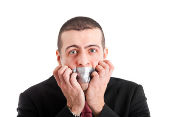 Portrait of a businessman having the mouth closed with tape