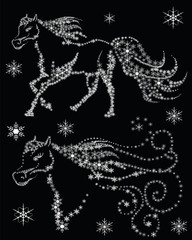silhouettes of horses in the snow flakes on a black background