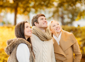 Fototapeta premium group of friends having fun in autumn park