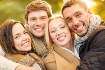 group of friends having fun in autumn park