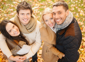 group of friends having fun in autumn park