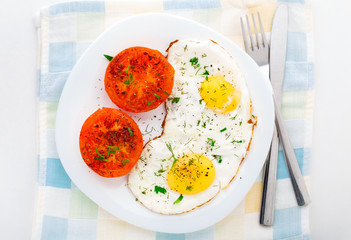Breakfast with fried eggs and tomato