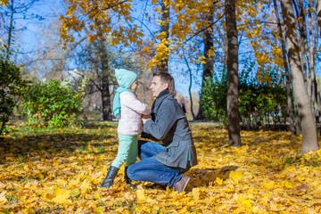 Happy father and little girl in autumn park