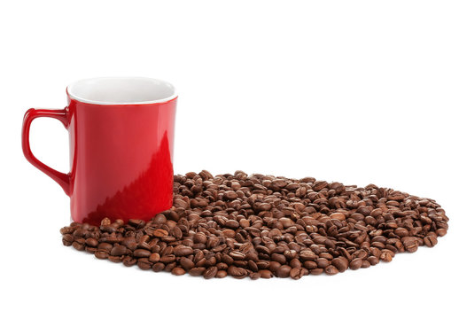 Red coffe cup into roasted coffee beans