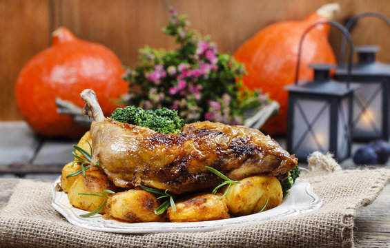 Roasted chicken with vegetables on wooden table