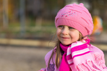 portrait of a little girl in a pink hat