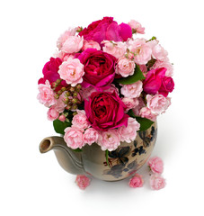 beautiful garden roses in a tea pot