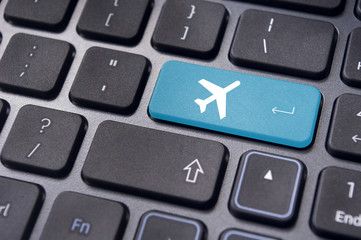 online booking of flight ticket, with plane sign on keyboard