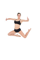 Fototapeta na wymiar Sporty woman jumping isolated on white background