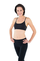 Fototapeta premium Portrait of a sporty young woman with hands on hips