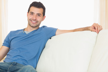 Casual happy man relaxing on couch