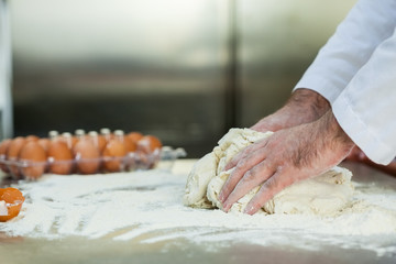 Close up of baker preparing dough