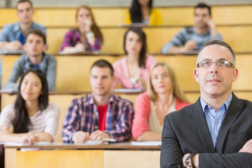 Elegant teacher with students at the lecture hall