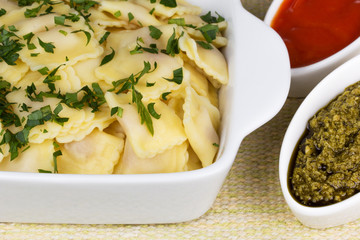 Italian pasta, ravioli with parsley and sauces